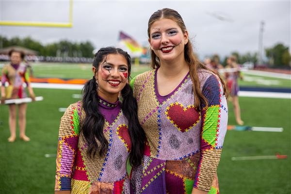 Two RHS colorguard members smile